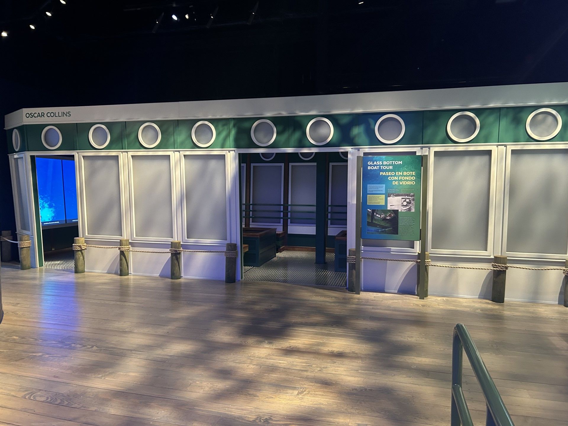 Entrance to an exhibit, featuring a green and white facade with circular lights, and open doorways.
