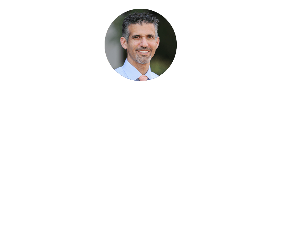 A man in a white shirt and tie is smiling in a circle.