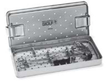 A stainless steel container filled with surgical instruments.