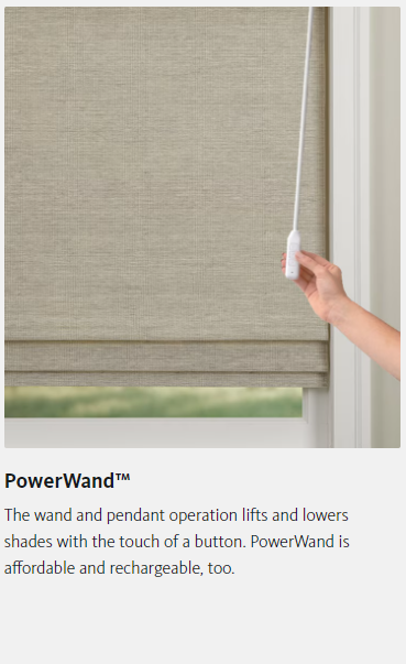 A person is holding a remote control over a window blind.