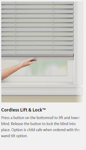A person is using a cordless lift and lock blind on a window.
