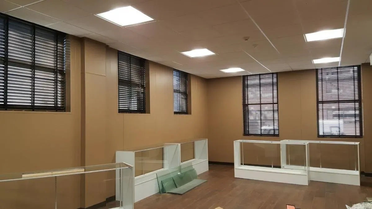 A room with a lot of windows and a wooden floor.