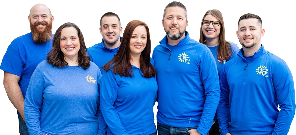 A group of people wearing blue shirts are posing for a picture.