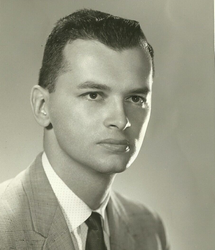 Portrait of Fred Chemidlin form Family Investors in a suit and tie against a plain background