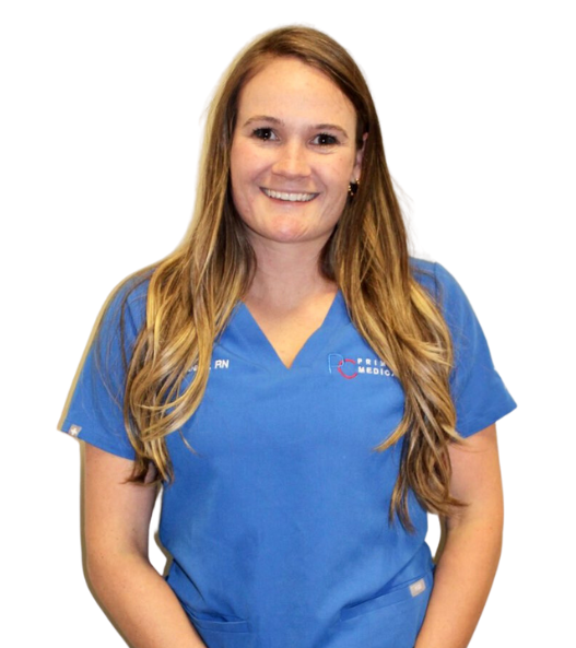 A woman in a blue scrub top is smiling for the camera