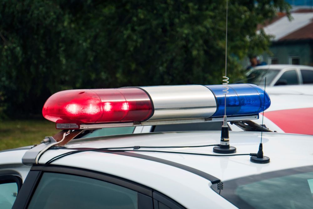 A Close Up Of A Police Car With A Red And Blue Light On Top Of It — Asset Security Group In King Creek, NSW