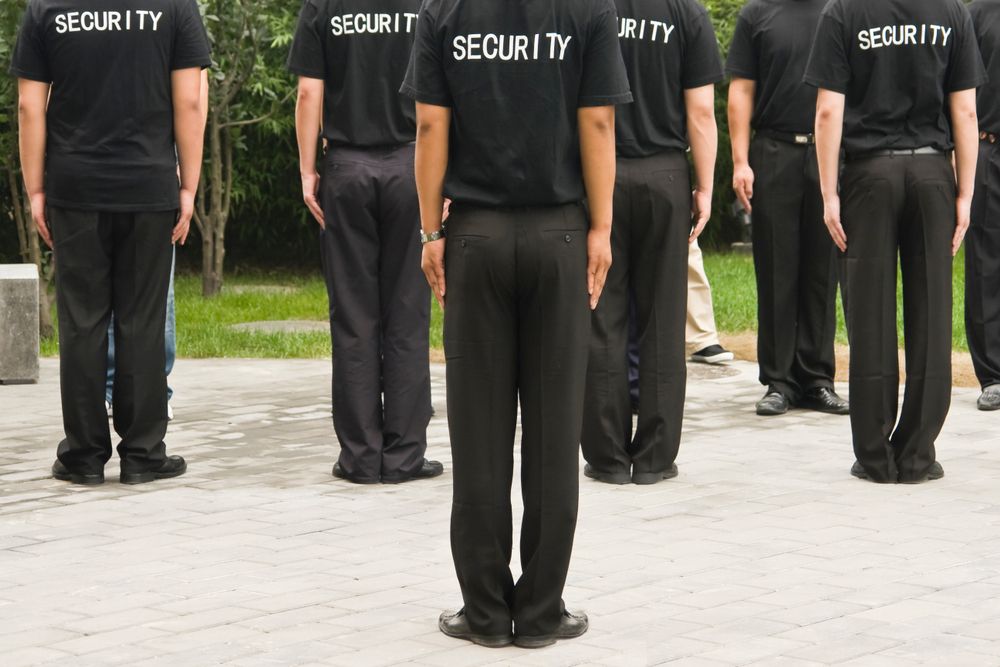 A Group Of Security Officers Are Standing In A Line — Asset Security Group In King Creek, NSW