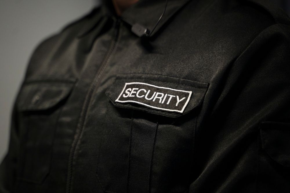 A Security Guard Has A Security Patch On His Jacket — Asset Security Group In King Creek, NSW