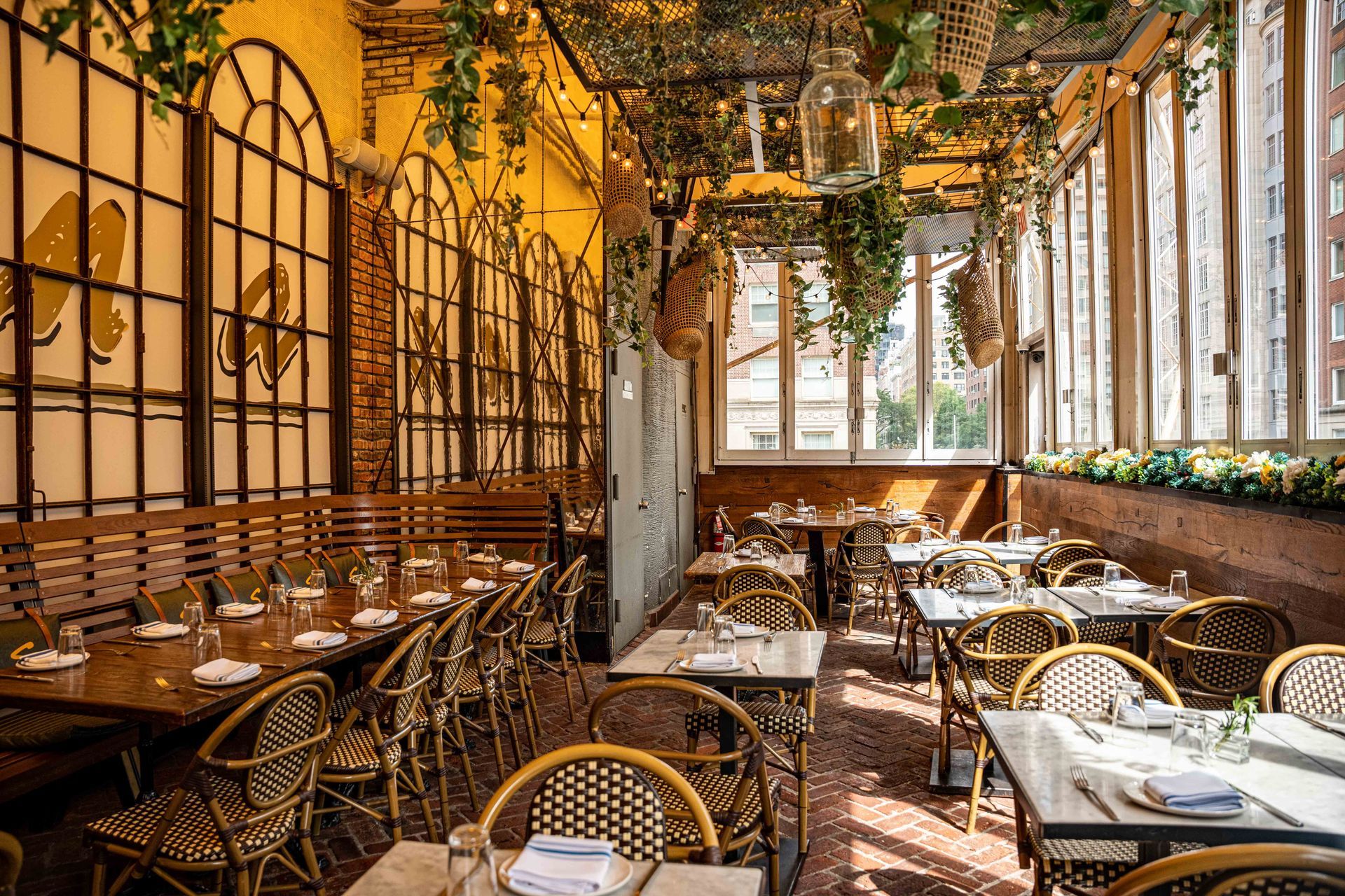 A restaurant with tables and chairs and a lot of windows