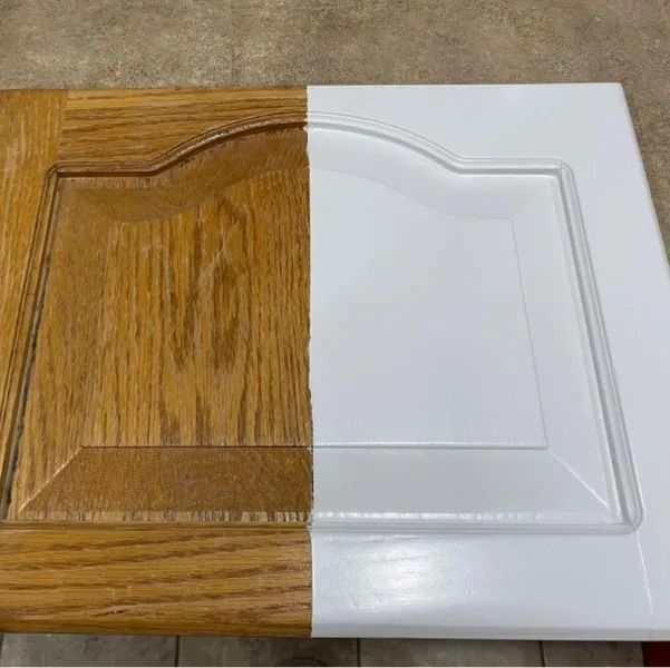 Split wood-finish and white cabinet door sample with raised panel design