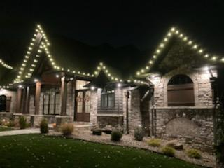house with Christmas lights on the roof at night — Louisville, OH — Mongiardo Power Wash