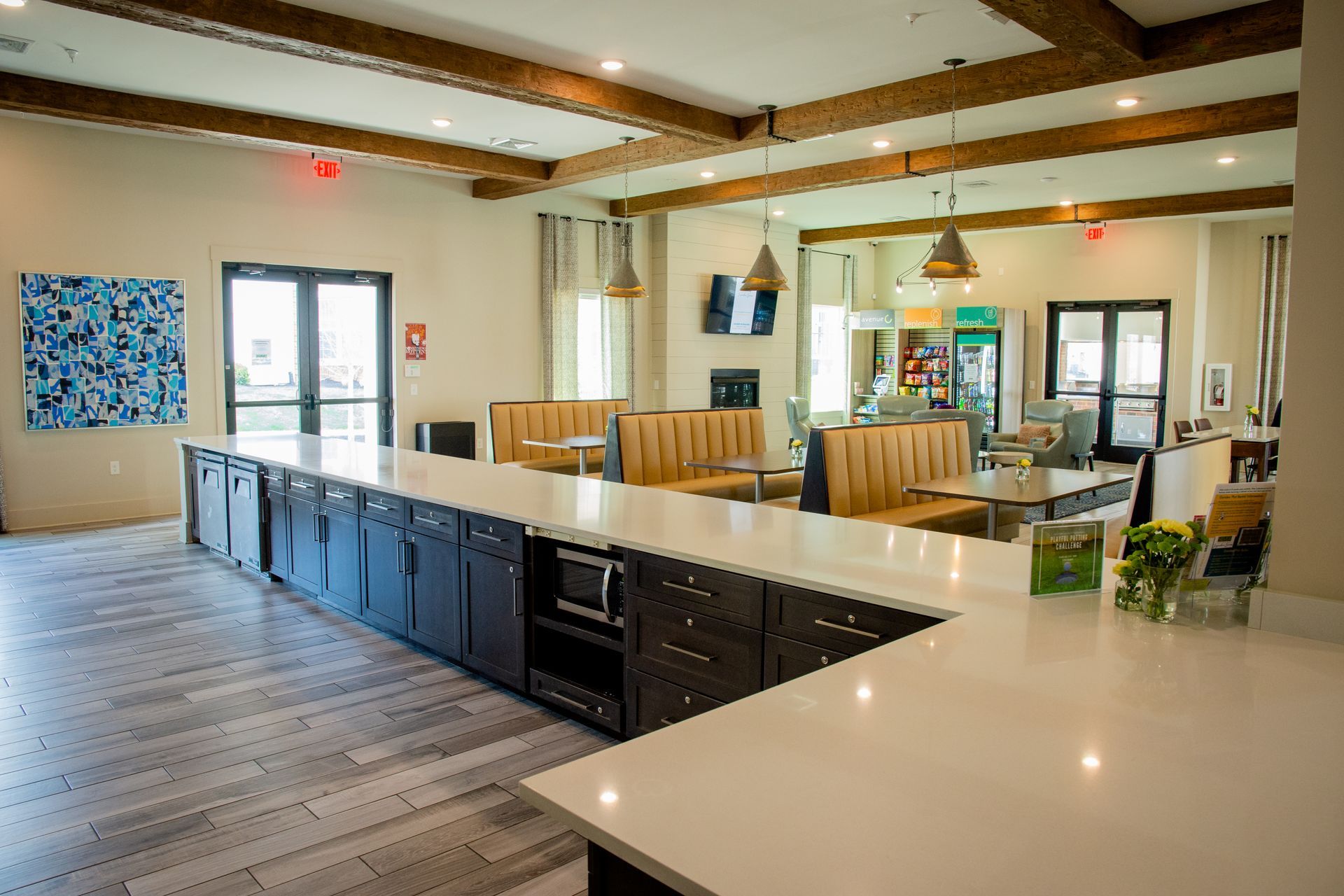 The room features a neutral color scheme, wooden beams, and an exterior door.