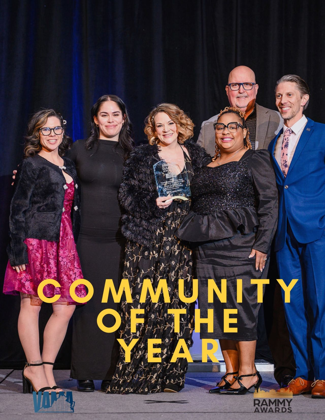 staff poses for community of the year win