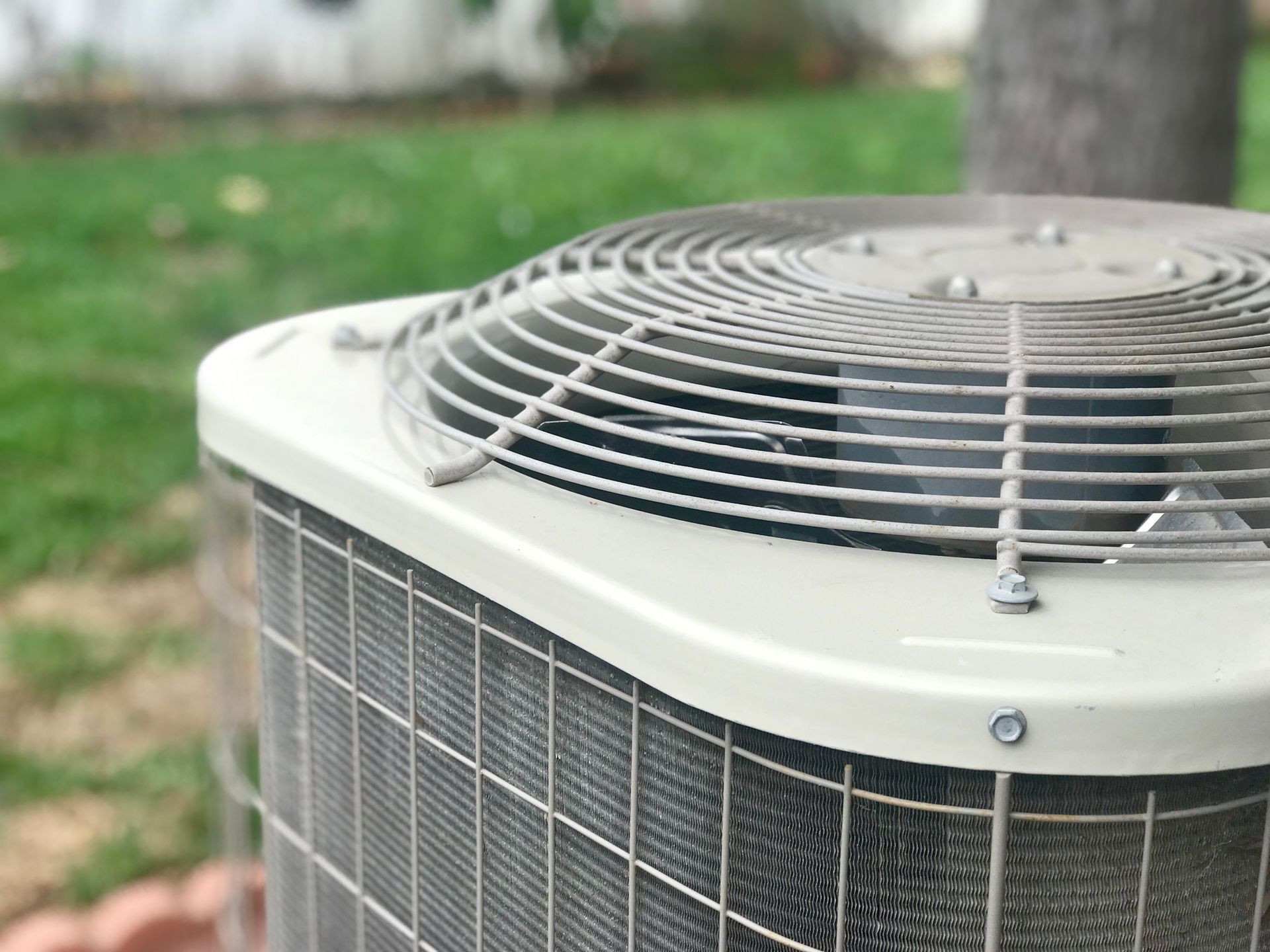 closeup view of an air conditioning unit outside a house.