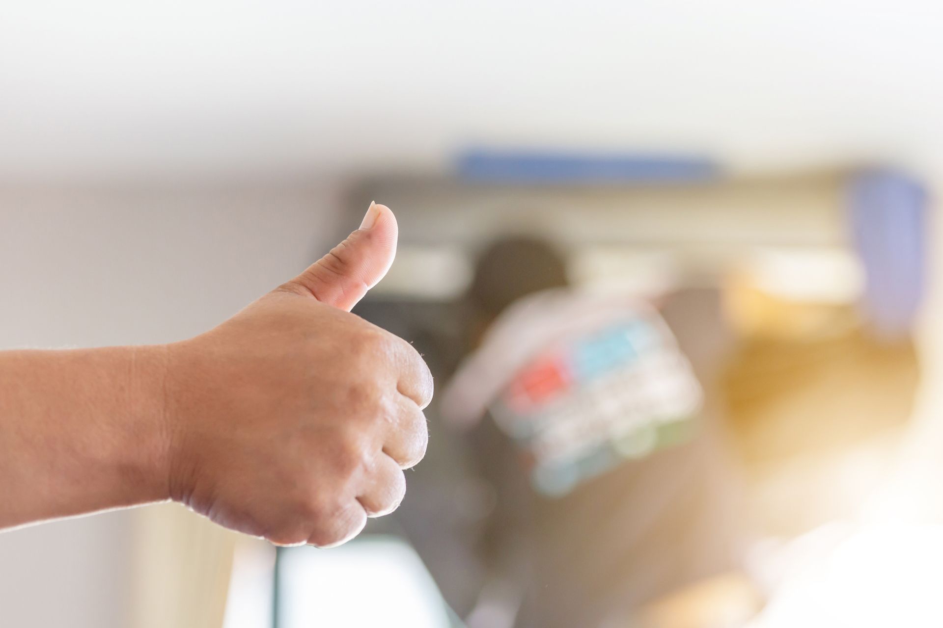 Close-up of hand repairing AC, showcasing success, representing a trusted AC contractor.