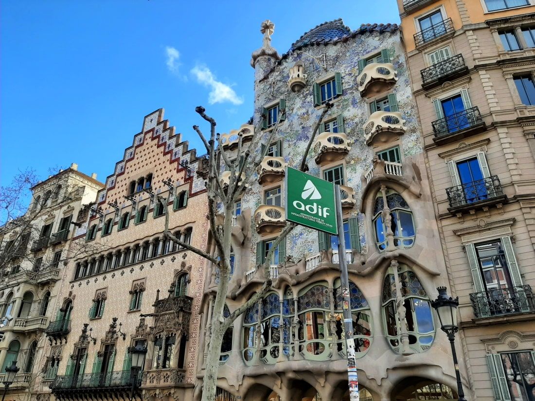 Casa Batlló Barcelona A building with a green sign that says ' cactus ' on it