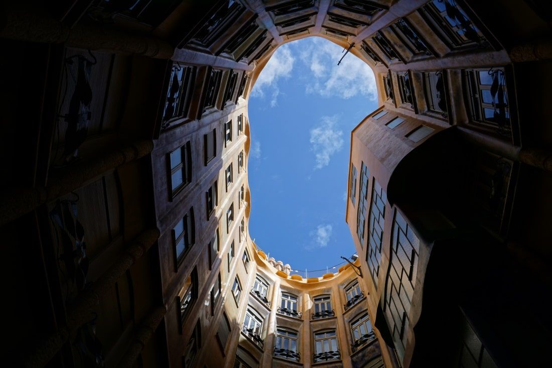Looking up at the sky through a hole in a building