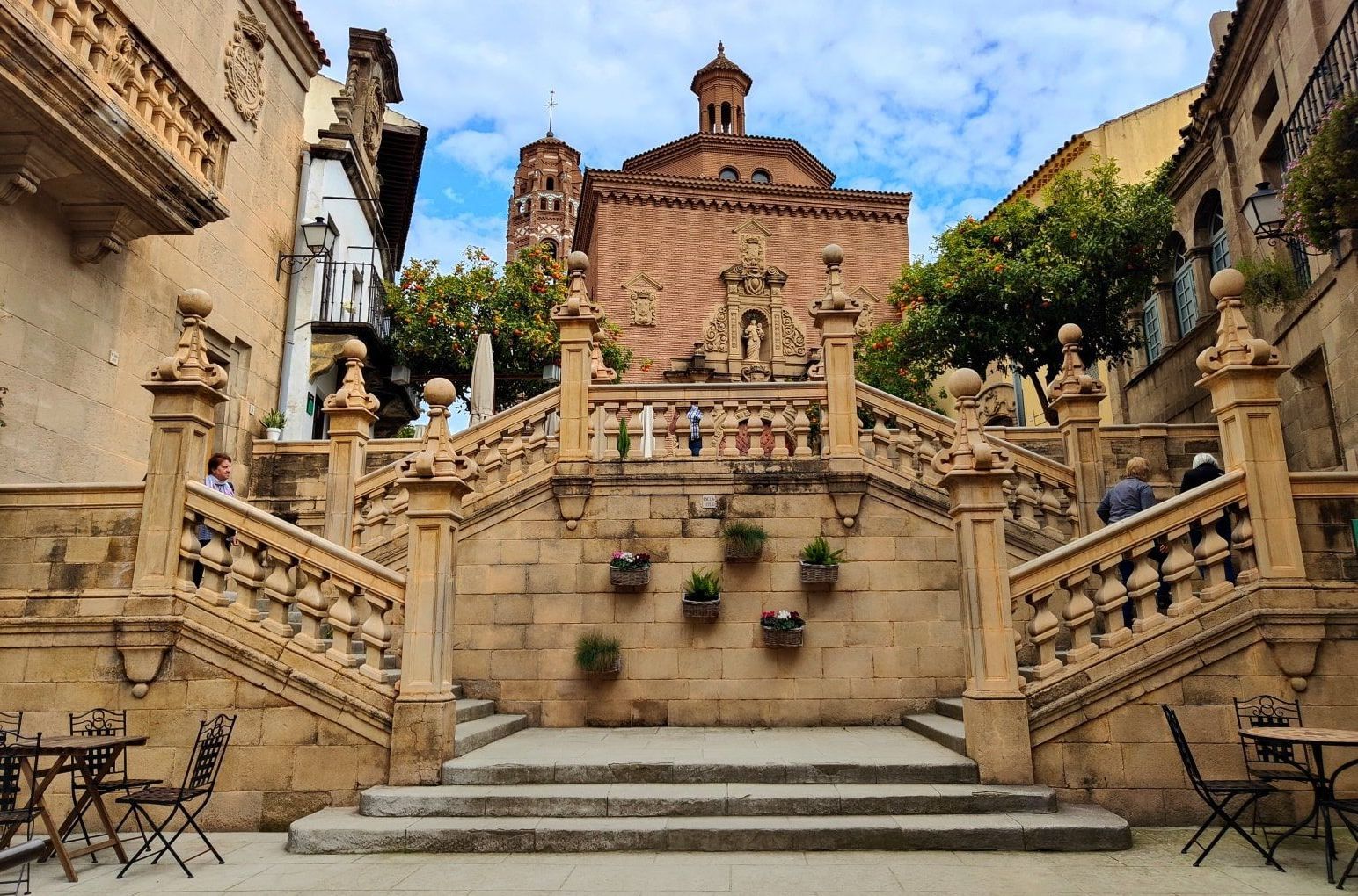 Barcelona Poble Espanyol Stairs leading up to a building with a church in the background