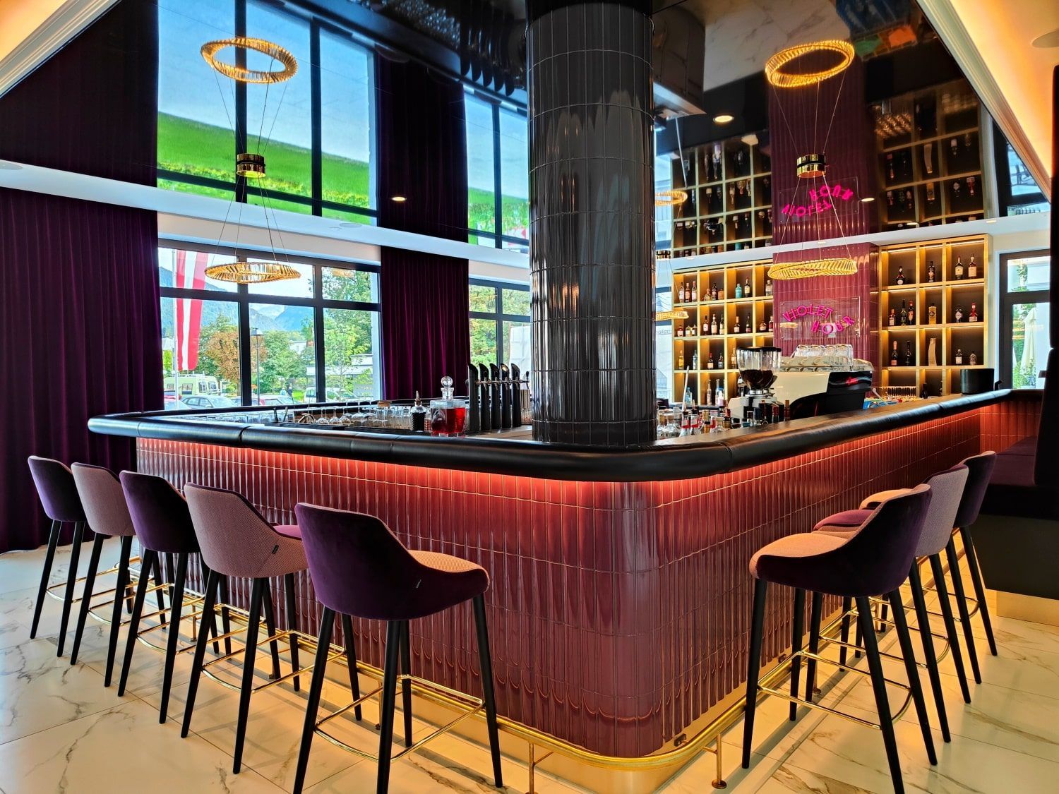 Grand Elisabeth Hotel Bar Upscale bar with purple accents and stools, large windows, and a dark column.