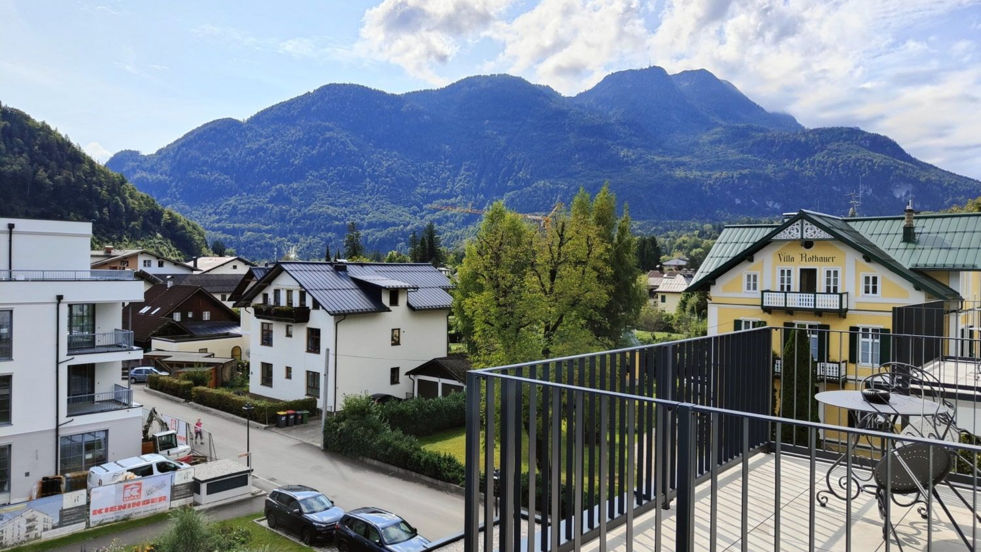 Grand Elisabeth Hotel Bad Ischl View of a town with houses and a mountain range under a cloudy sky.