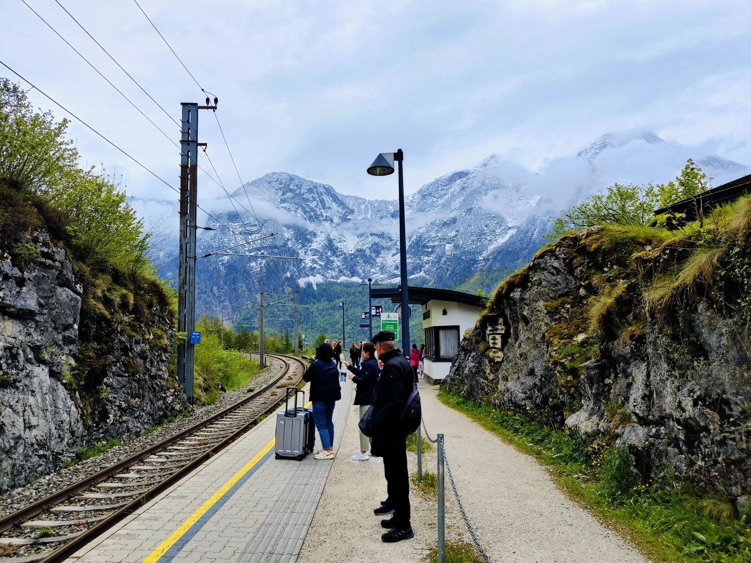 Hallstatt Bahnhof People waiting for a train with mountains in the background