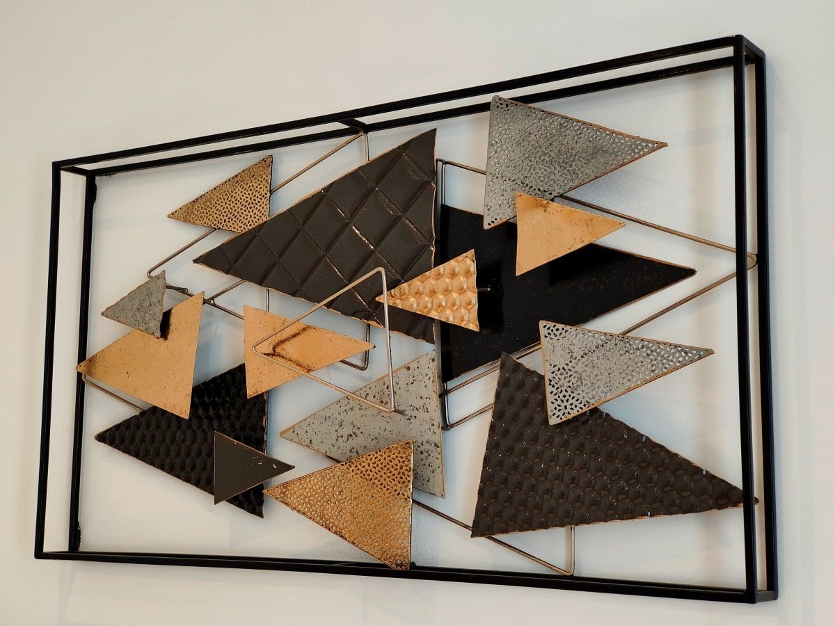 A picture frame with triangles on it is hanging on a wall
