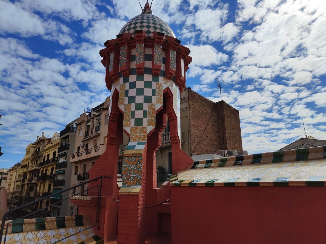 A red building with a checkered dome on top of it