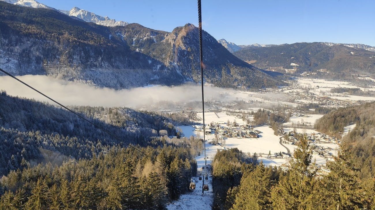 Jennerbahn A ski lift going up a snowy mountain