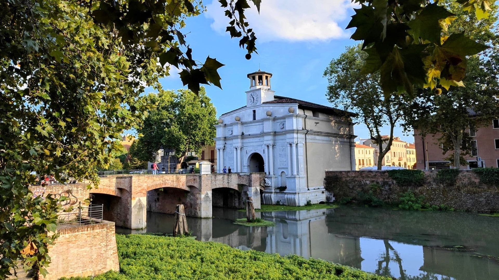 Padua A bridge over a river with a building in the background
