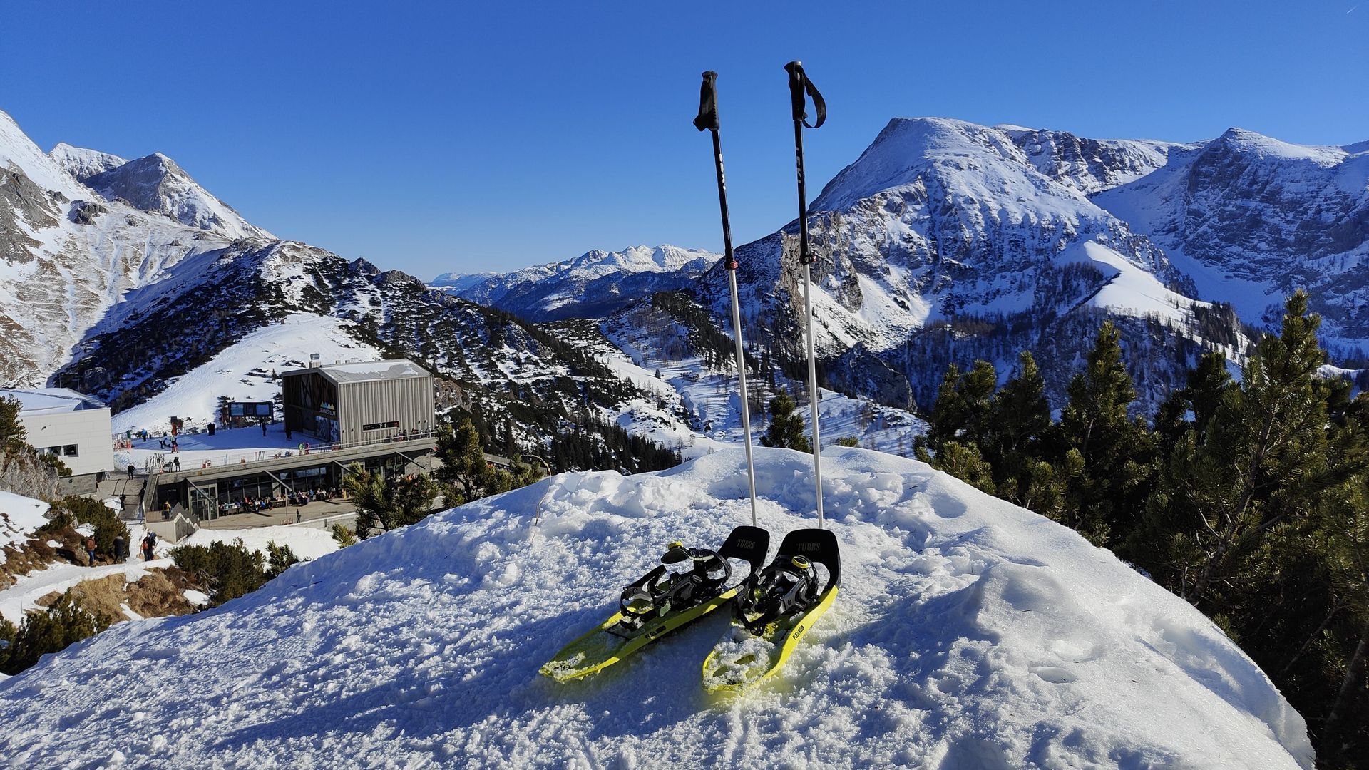 Schneeschuhwanderung A pair of snowshoes laying on top of a snow covered mountain