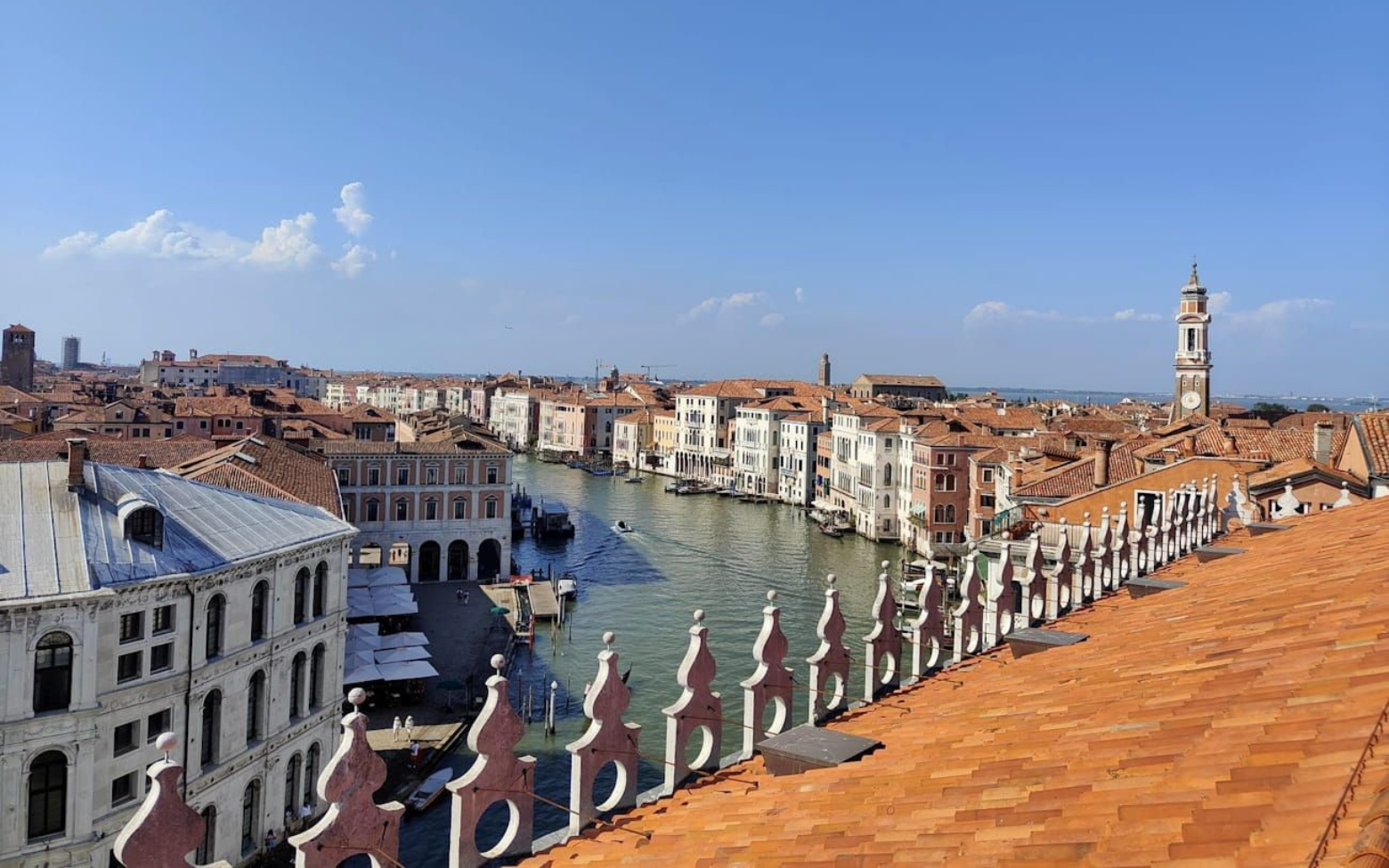 Venedig - Aussicht vom Kaufhaus High-angle view of the Grand Canal in Venice, Italy, framed by decorative rooftop tiles and a historic stone facade.