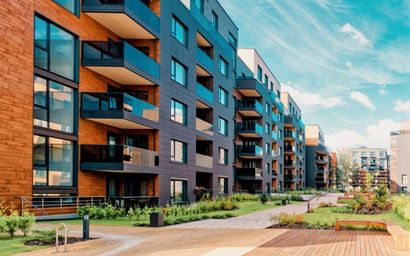 A row of apartment buildings with balconies in a residential area.