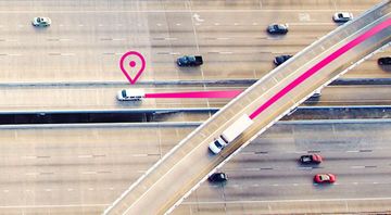 An aerial view of a highway with cars driving on it.