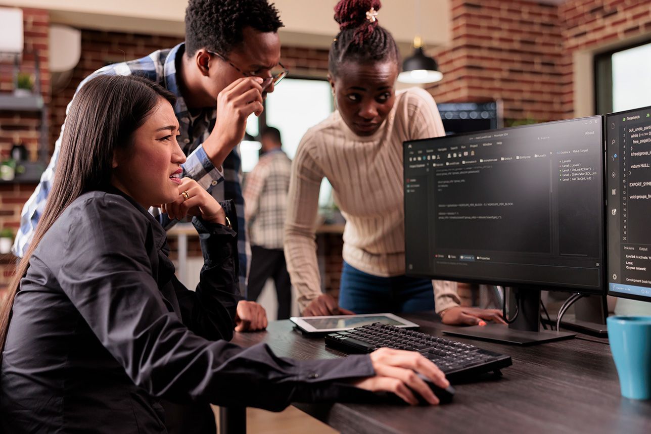 A group of people are looking at a computer screen.