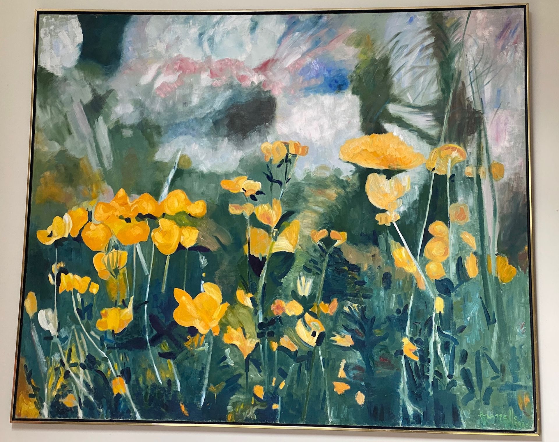 A painting of yellow flowers is hanging on a wall.