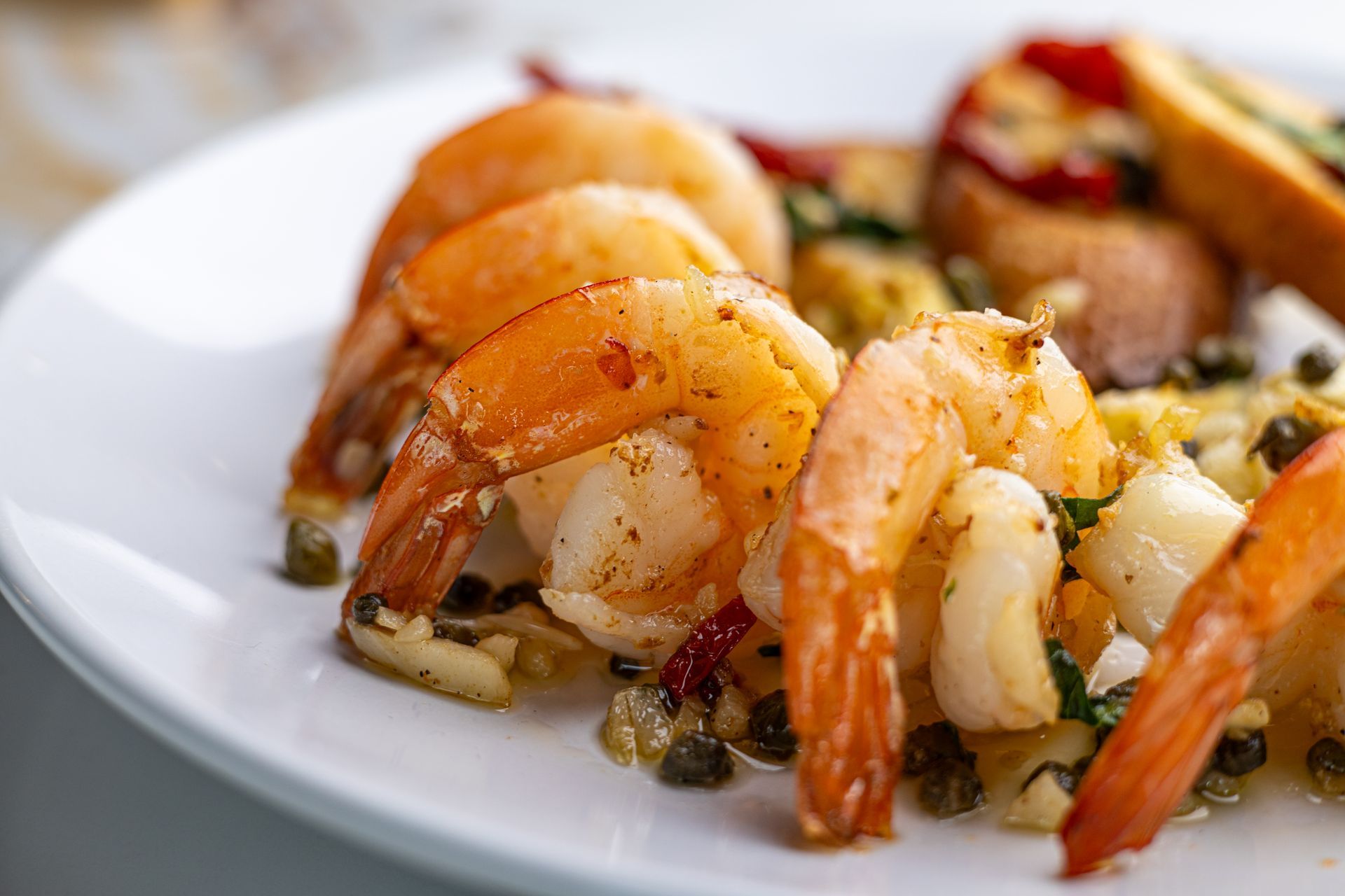 A close up of a plate of shrimp on a table.