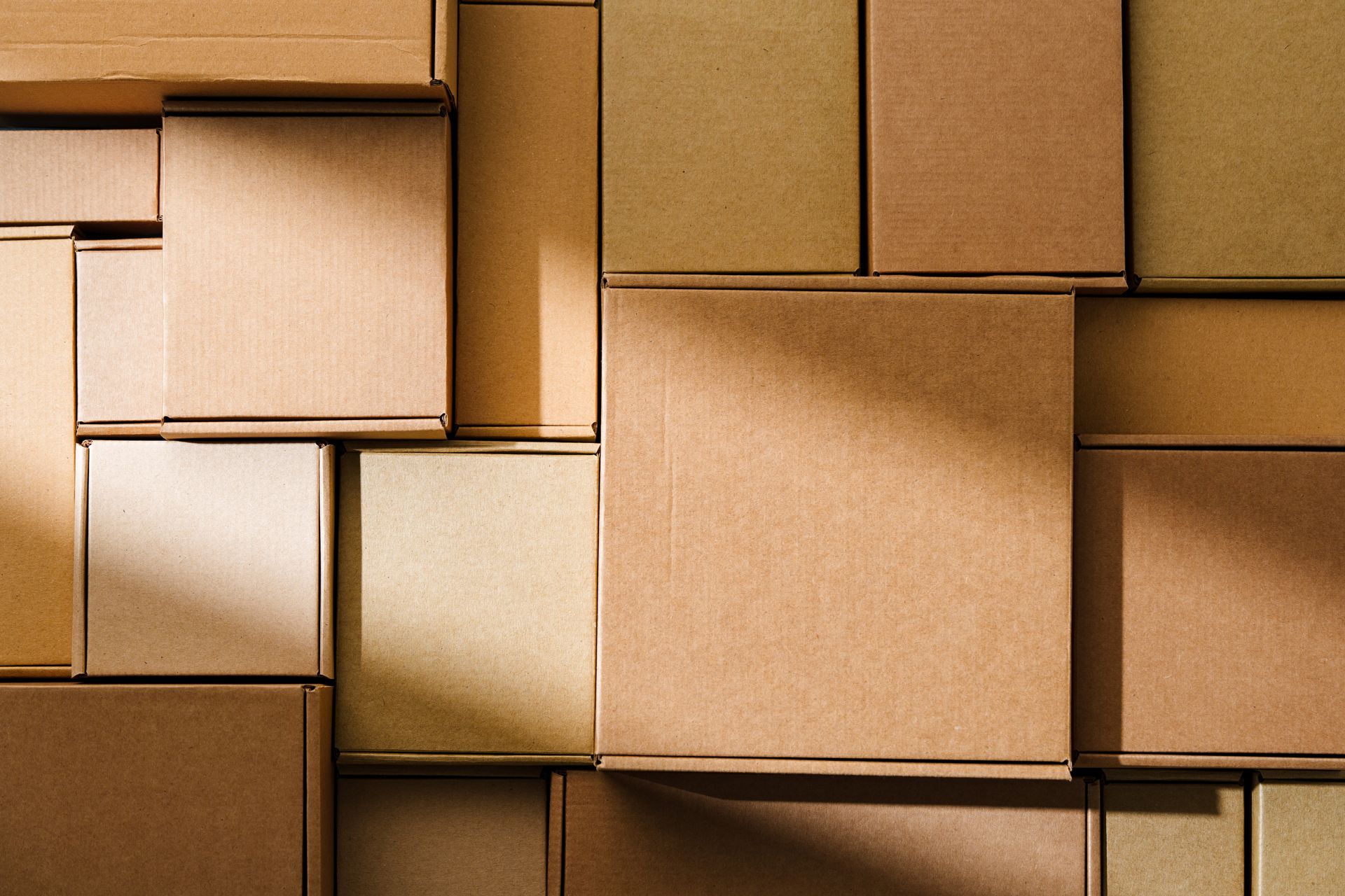 Stacked brown cardboard boxes in a close-up pattern