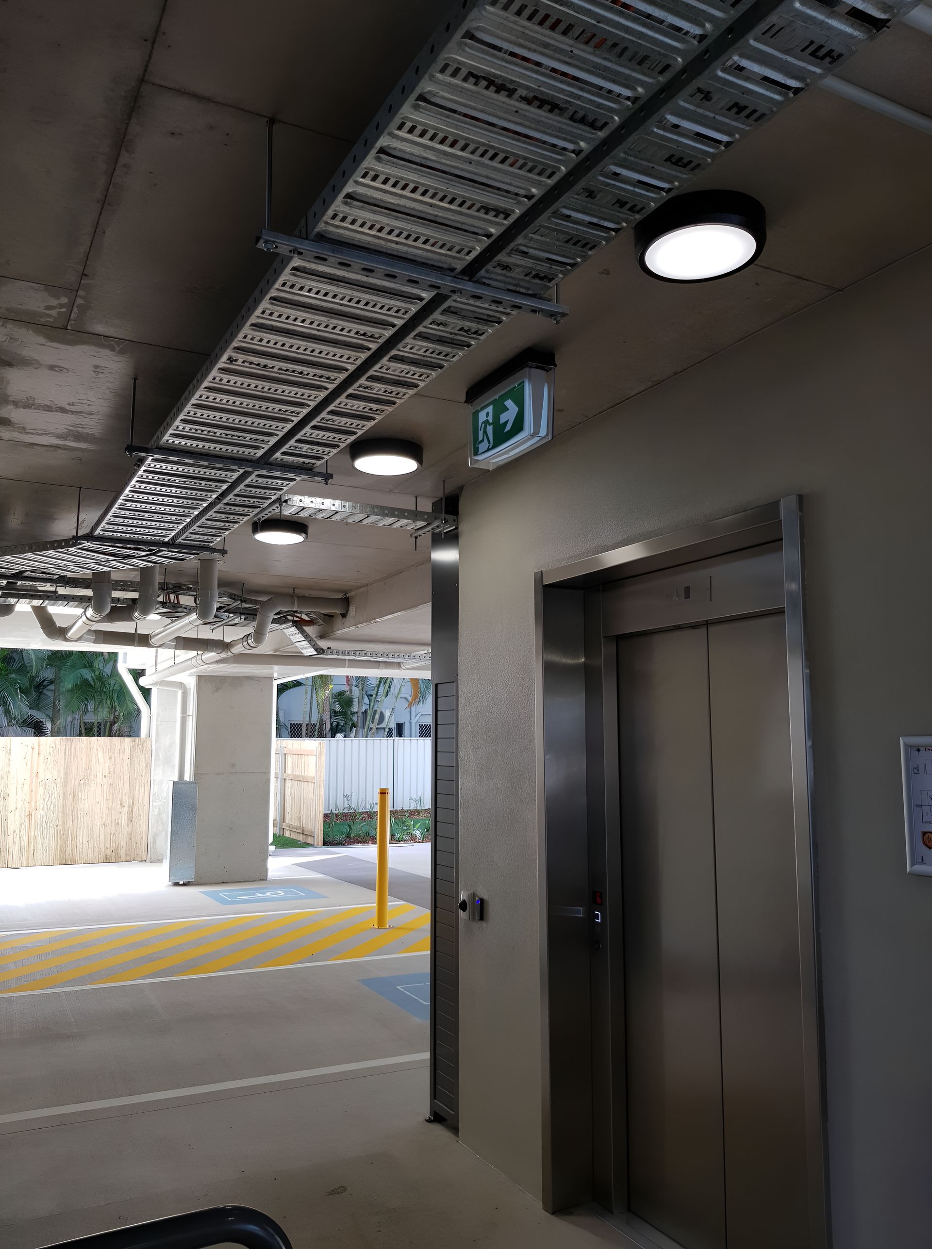 A Stainless Steel Elevator Is In A Parking Garage — Waltlec Industries In Garbutt, QLD