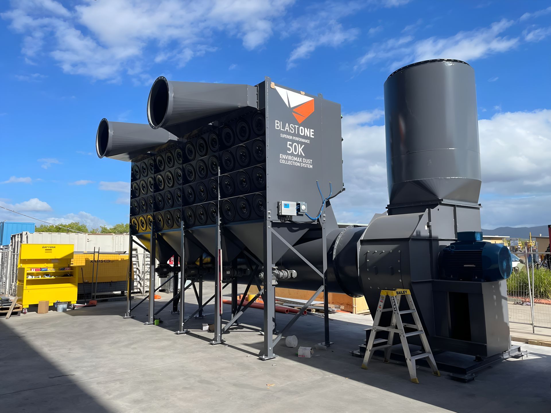 A Large Black Machine Is Sitting In A Parking Lot — Waltlec Industries In Garbutt, QLD