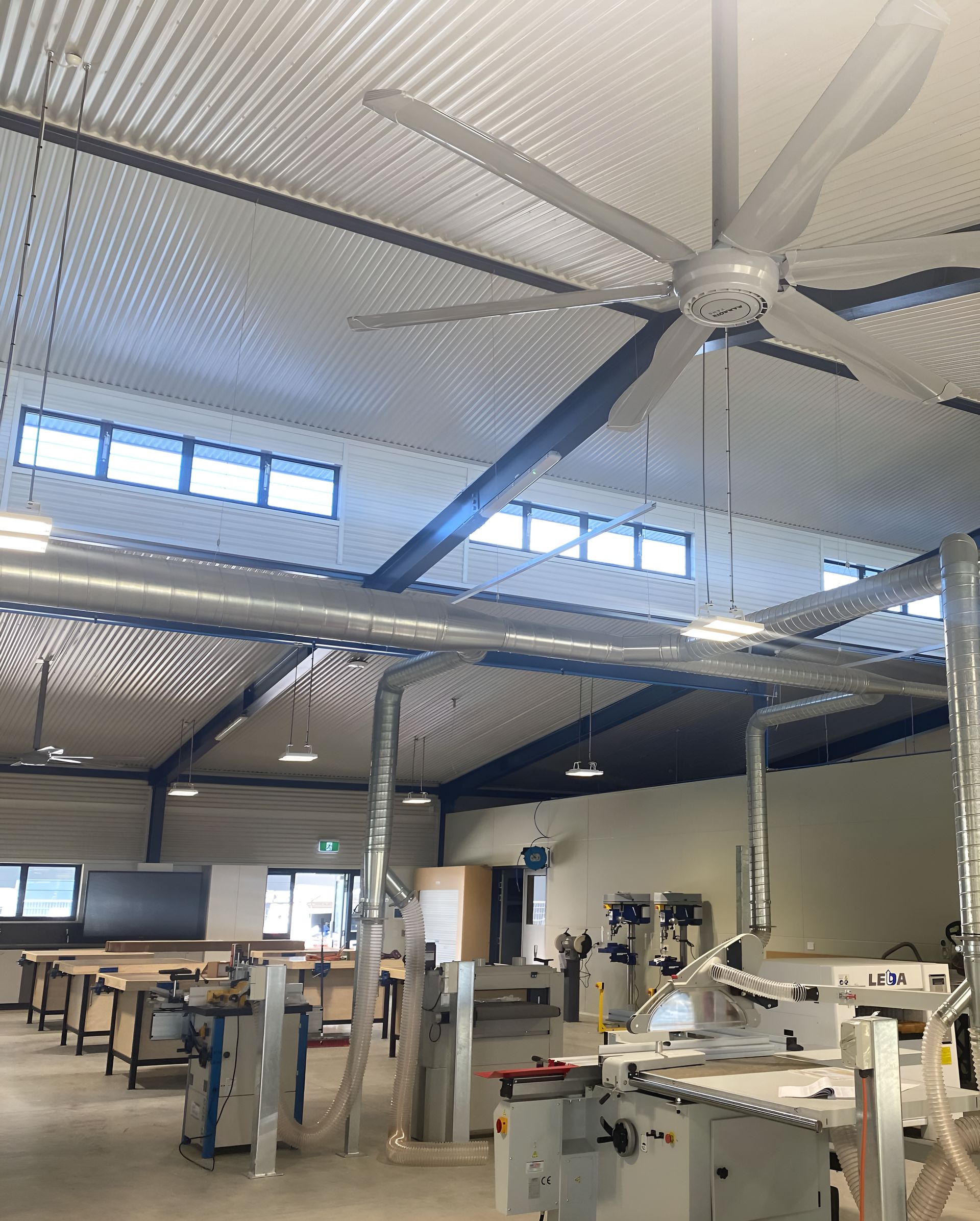 A Large Ceiling Fan Is Hanging From The Ceiling Of A Building — Waltlec Industries In Garbutt, QLD