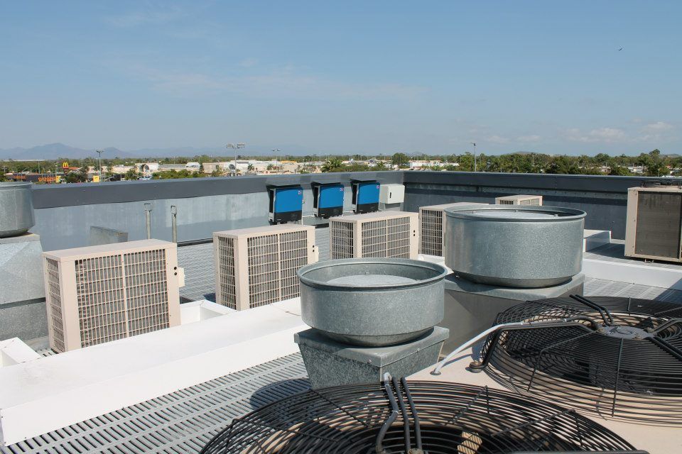 A Rooftop With A Lot Of Air Conditioners On It  — Waltlec Industries In Garbutt, QLD