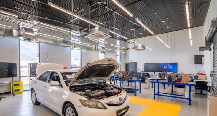 A White Car Is Parked in A Garage with Its Hood Open — Waltlec Industries In Garbutt, QLD