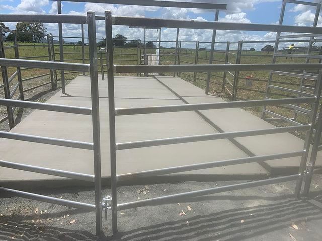 Metal Fence Surrounds a Concrete Platform in a Field — Pedro's Concreting in Millmerran, QLD