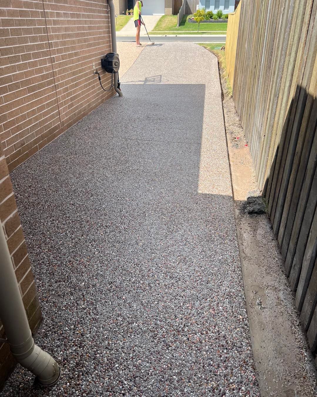 A Sidewalk Leading to a House With a Brick Wall and a Fence — Pedro's Concreting in Pittsworth, QLD