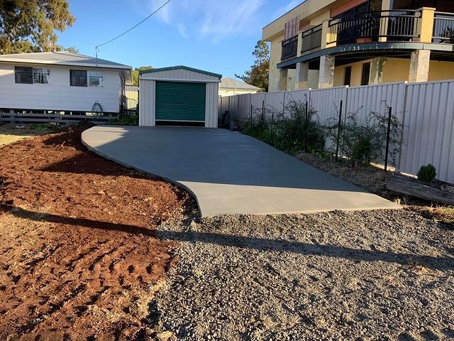 Concrete Driveway Pouring In Front Of House — Pedro's Concreting in Highfields, QLD