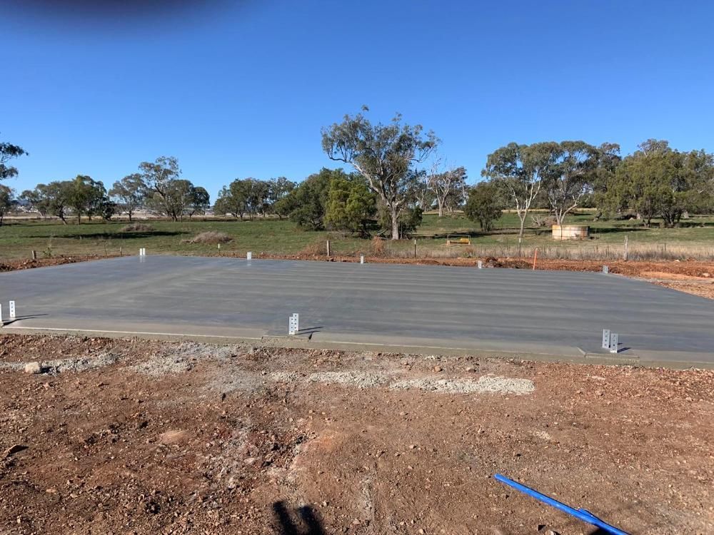 Large Concrete Slab is Sitting in the Middle of a Dirt Field — Pedro's Concreting in Highfields, QLD