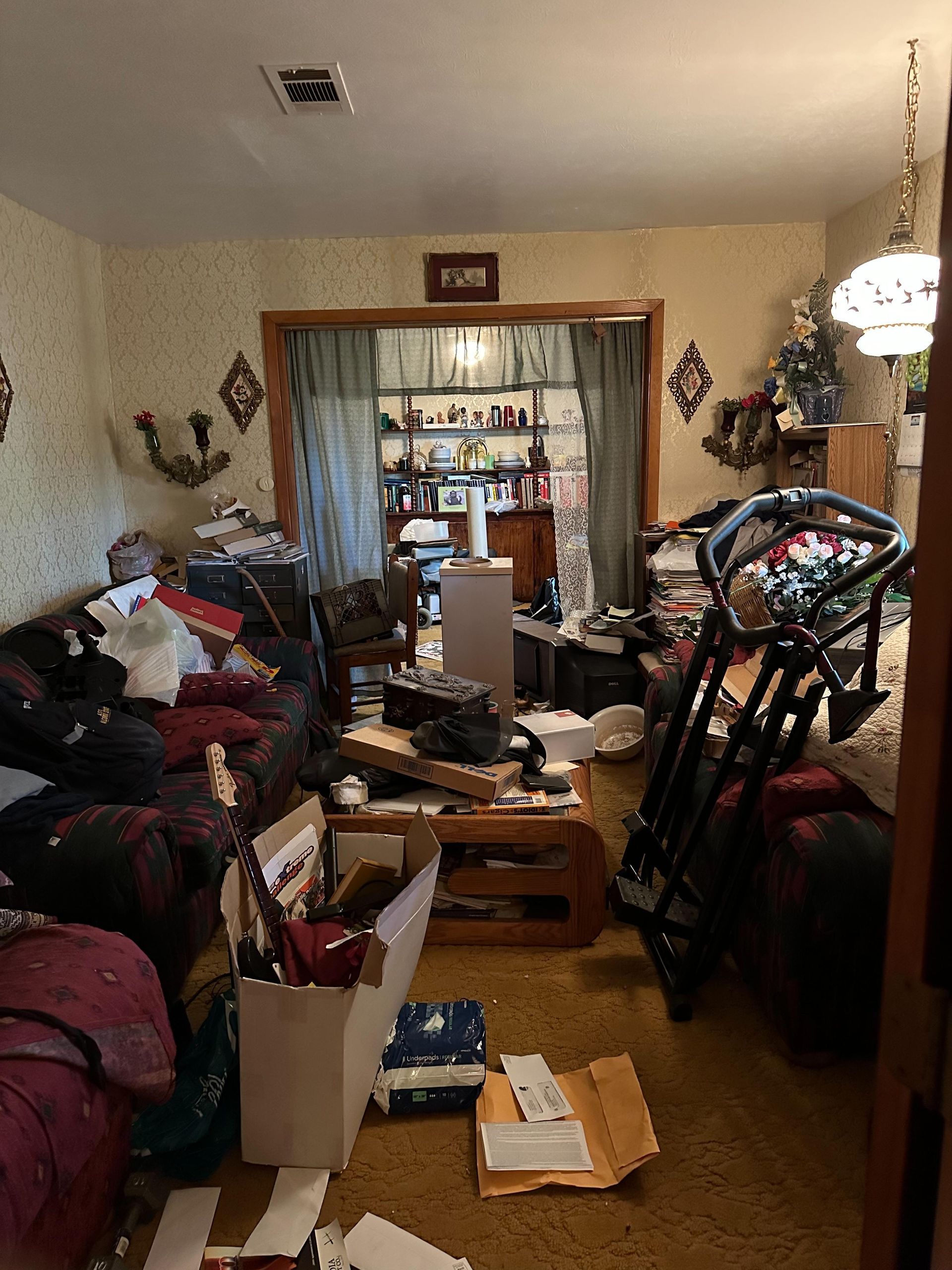 A living room filled with furniture and a treadmill.