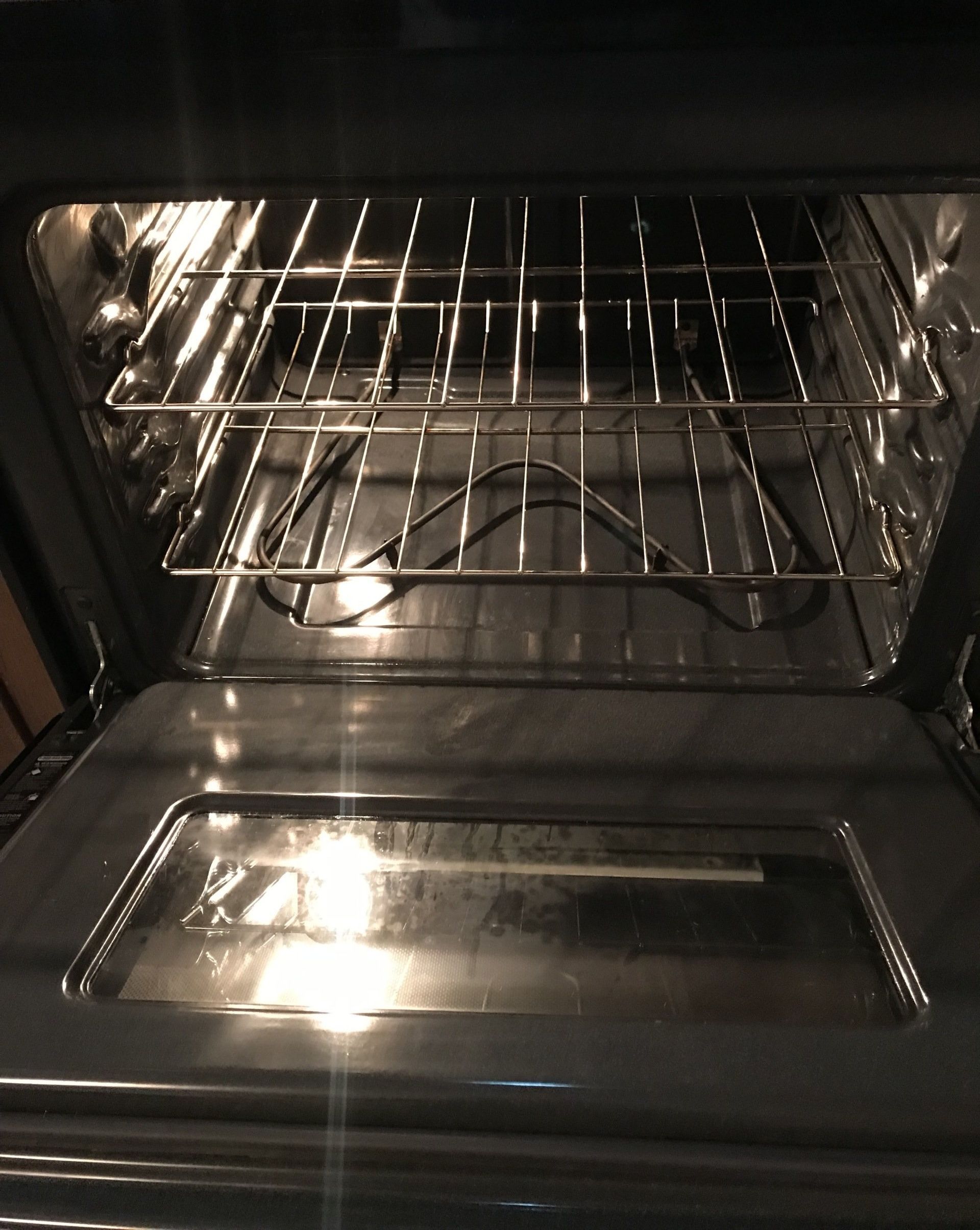 The inside of an oven is shown with the door open.