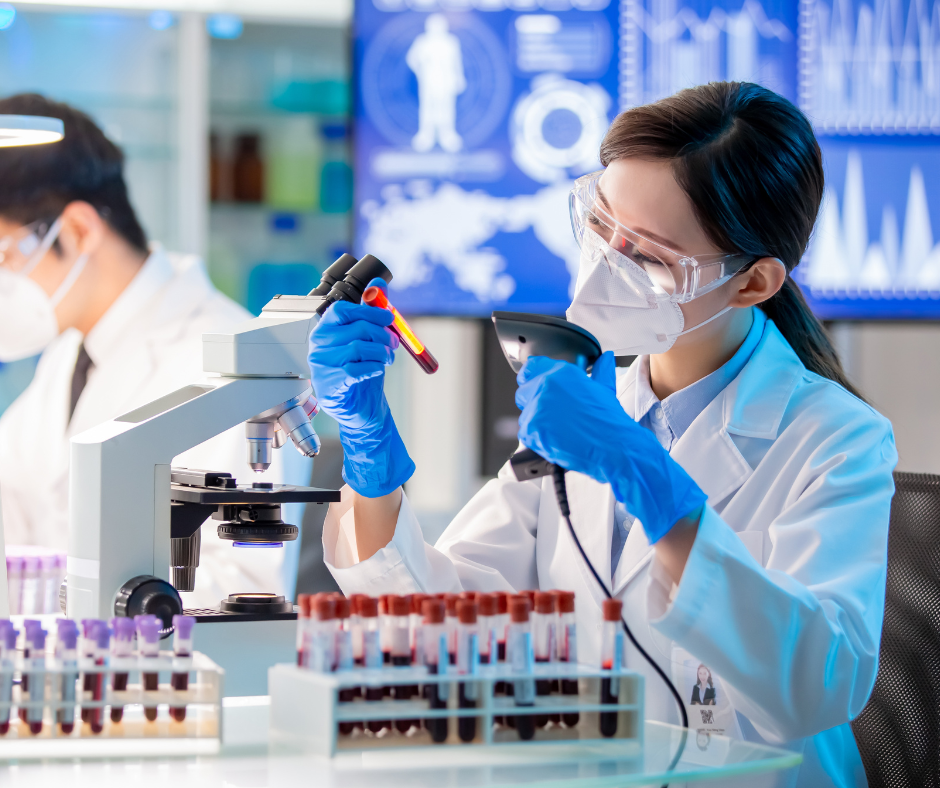 A female scientist is looking through a microscope in a laboratory.