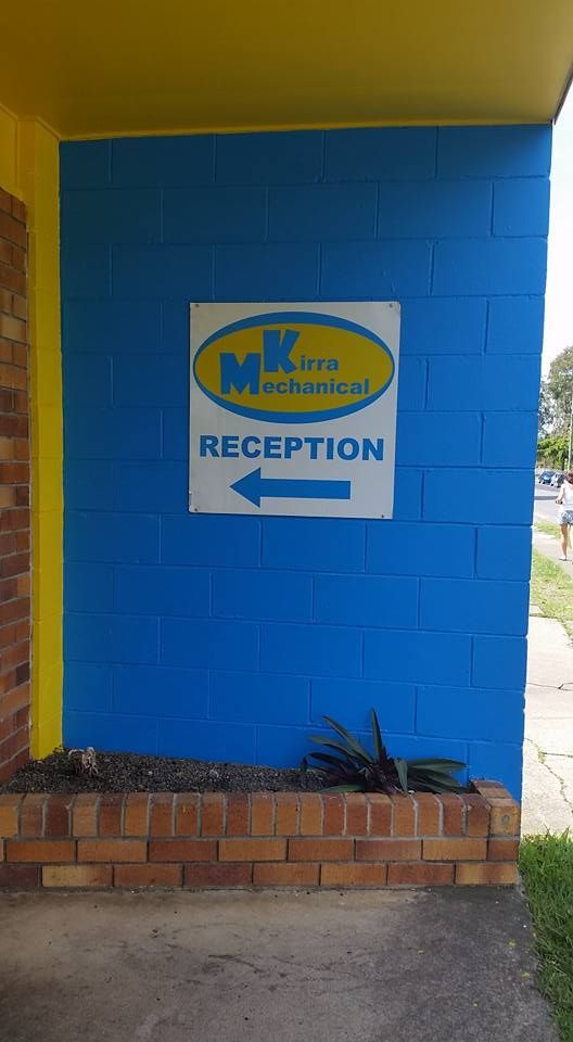 Blue and Yellow Brick Wall With a Sign on It Pointing to the Reception — Kirra Mechanical in Coolangatta, QLD